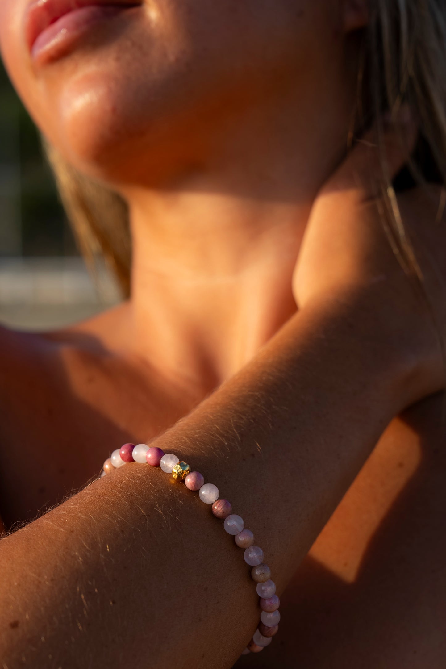 Young woman wearing a Soul and Stone hand-knotted gemstone bracelet.
