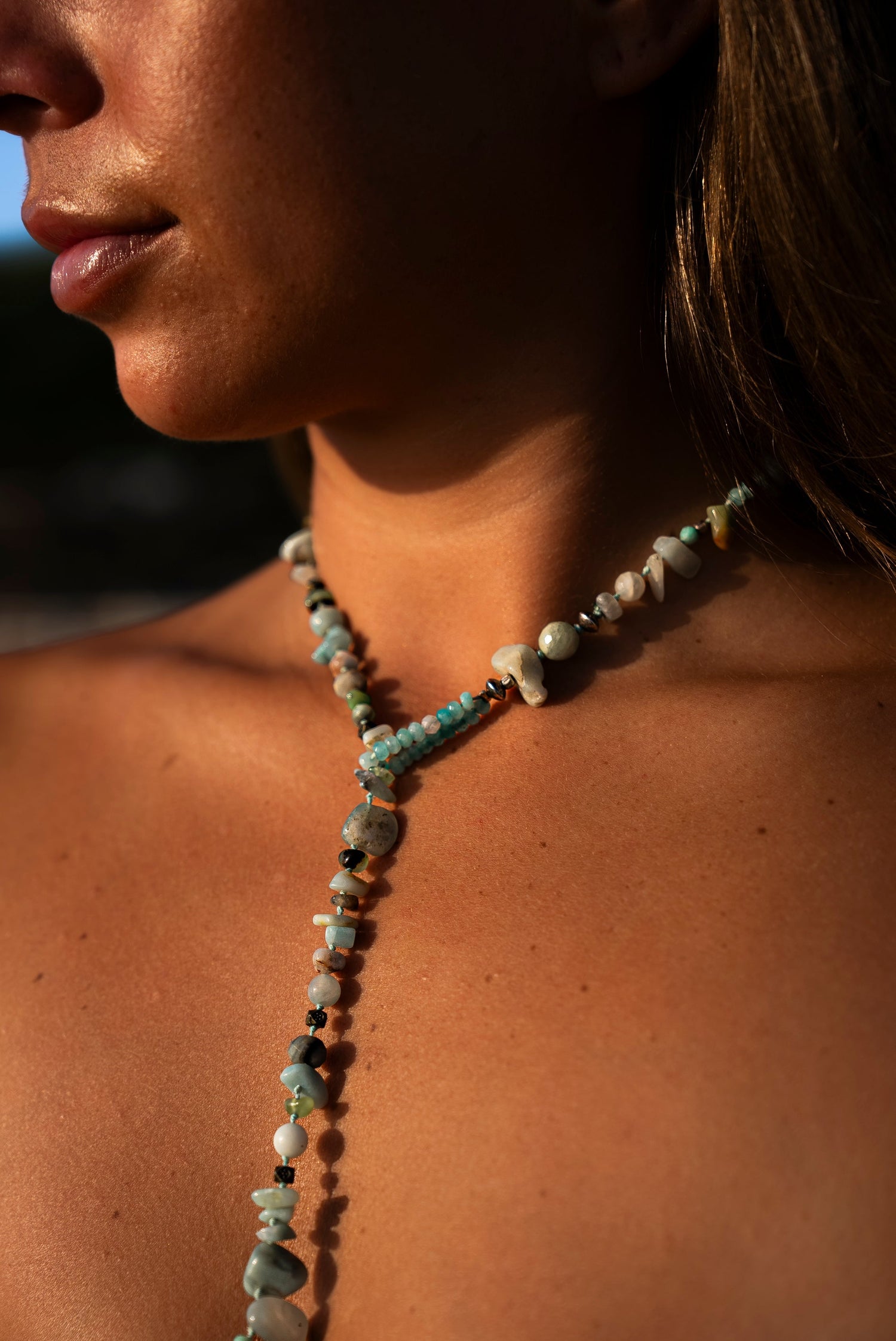 Young woman wearing a Soul and Stone gemstone lariat necklace.