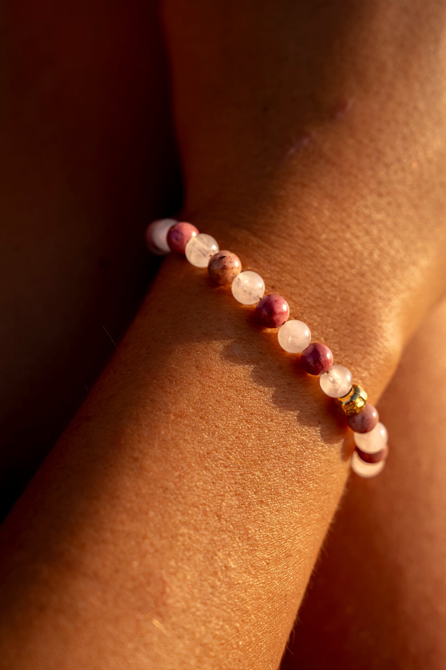 Young woman wearing a Soul and Stone hand-knotted gemstone bracelet.