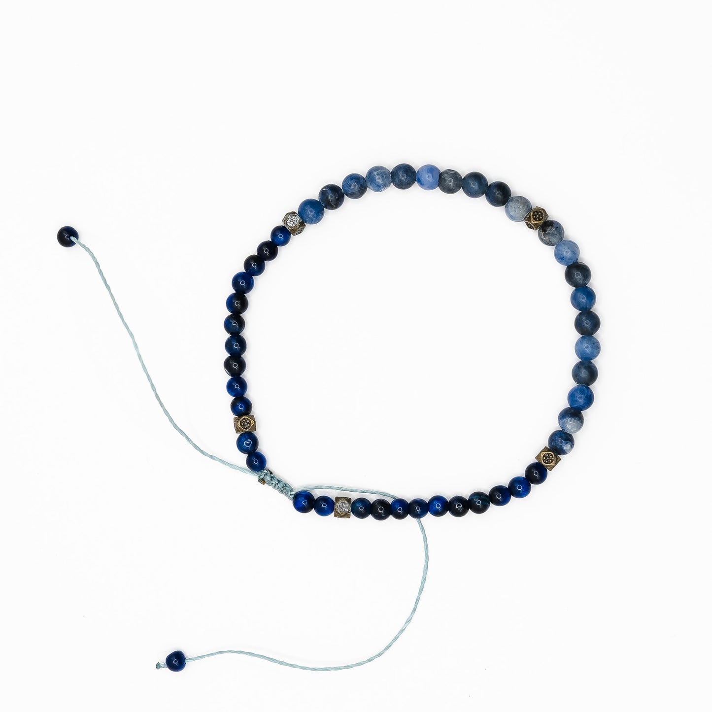 A Blue Tigers Eye Sliding Knot Anklet laid on a white background.