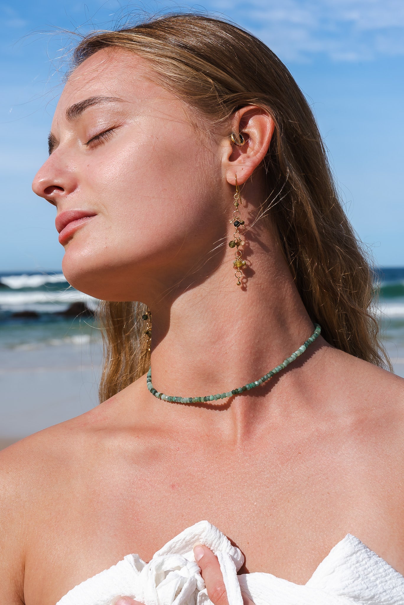 Young woman wearing a pair of Soul and Stone Drop Gemstone Earrings.
