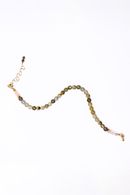 A Soul and Stone Green Garnet and Citrine Beaded Bracelet laid on a white background.