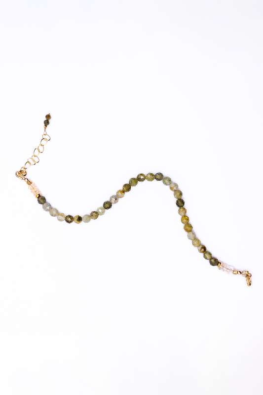 A Soul and Stone Green Garnet and Citrine Beaded Bracelet laid on a white background.