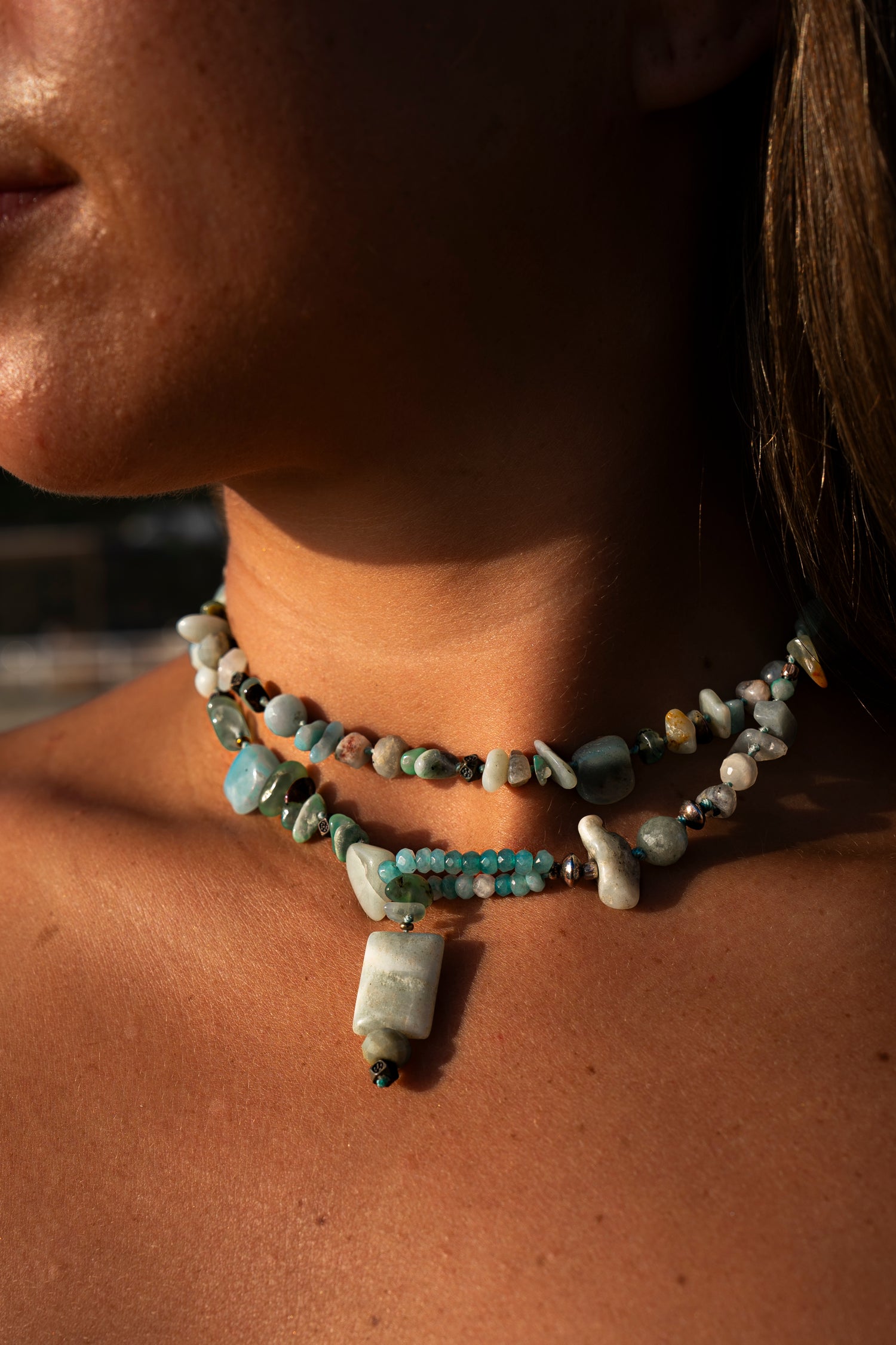 Young woman wearing a Soul and Stone gemstone lariat necklace in a choker style.