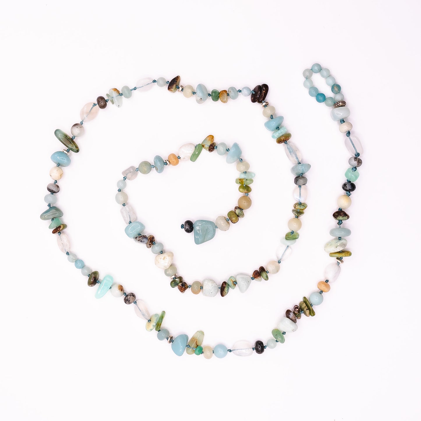 A product image of a Soul & Stone hand-knotted gemstone lariat necklace coiled on a white background.