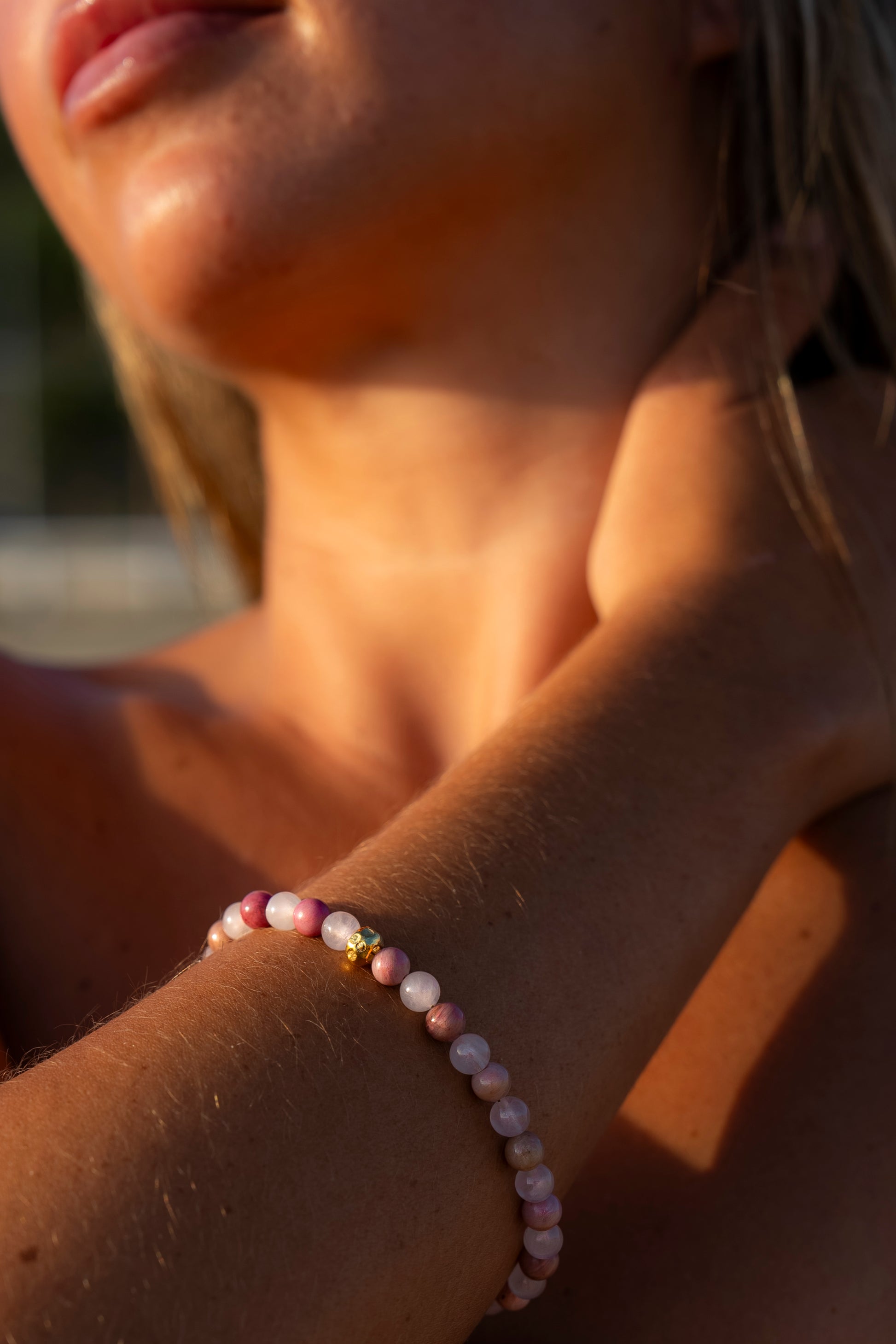 Young woman wearing a Soul and Stone hand-knotted gemstone bracelet.