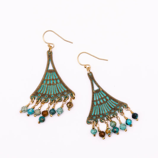 A pair of Soul and Stone Patina Hand-Turned Gemstone Earrings laid on a white background.