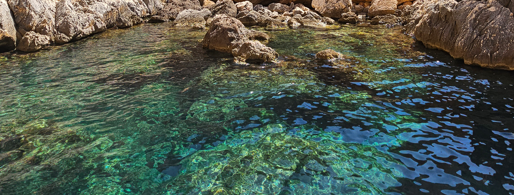 Picture of the vibrant green and blue water on the coast of Sardinia, Italy.